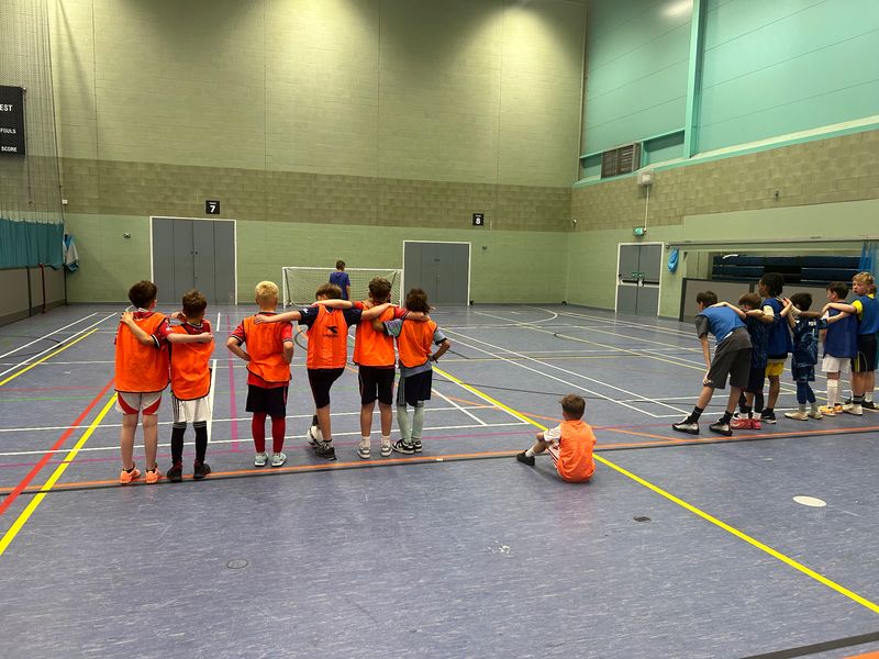 Two teams of children smiling together during a lively sports party